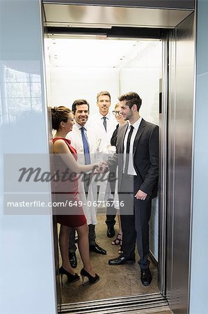 Doctors and business people in elevator