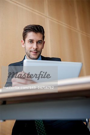 Businessman using tablet computer at desk