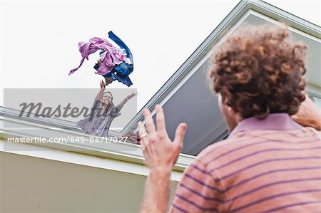 Woman throwing out boyfriends clothes Woman throwing out boyfriends clothes