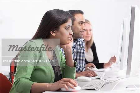 People using computers at desk