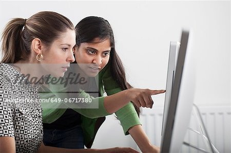 Teacher helping student use computer