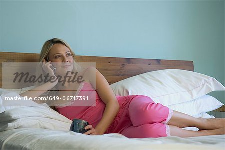 Woman talking on phone in bed