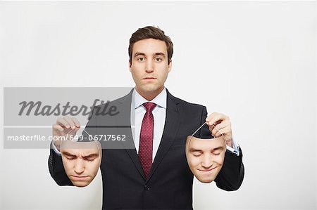 Businessman holding masks Businessman holding masks