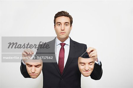 Businessman holding masks