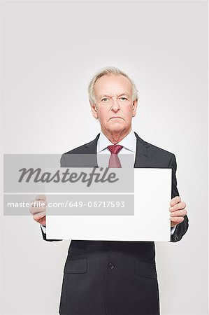 Businessman holding blank card