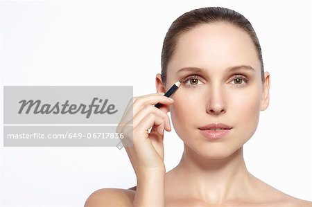 Close up of woman applying makeup