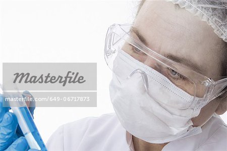 Doctor in face mask using tablet computer