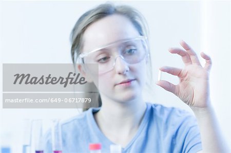Scientist examining pill in lab