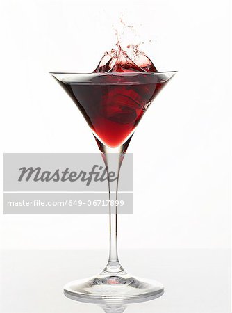 Cocktail splashing in glass Cocktail splashing in glass