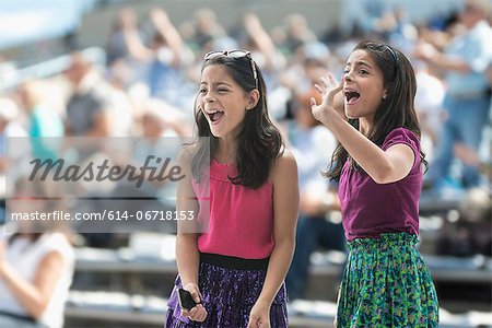 Two excited girls at a pop concert