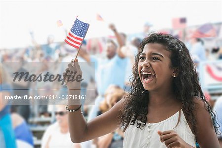 Girl cheering and waving american flag