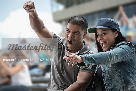 Excited couple at sports game Excited couple at sports game