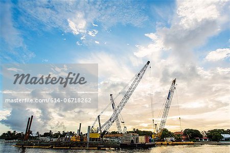 Construction cranes on waterfront