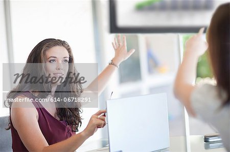 Businesswomen pointing to graph Businesswomen pointing to graph