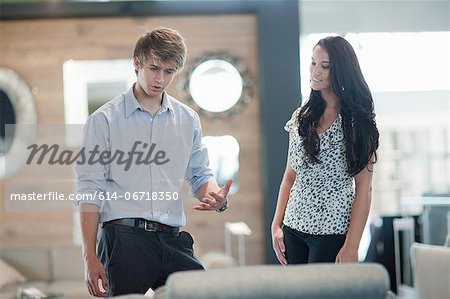 Woman shopping with salesman in store