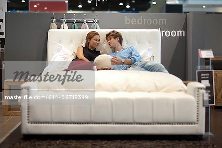 Couple shopping for mattress in store