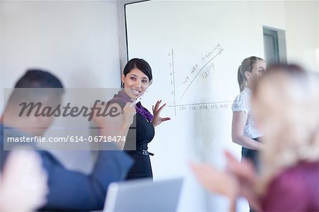 Businesswoman making graph on glass