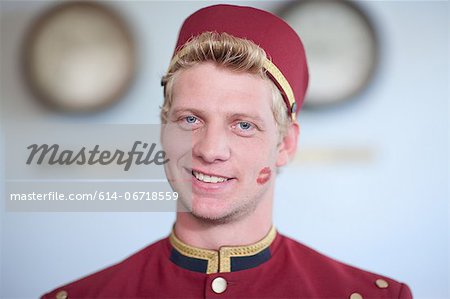 Bellhop smiling with kiss print on cheek