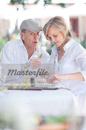 Older couple eating together outdoors