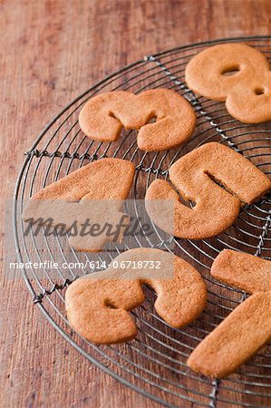 Cookies in number shapes on cooling rack