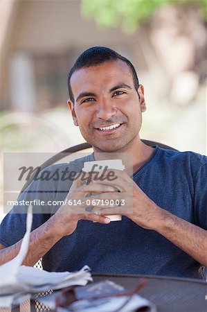 Man having cup of coffee outdoors