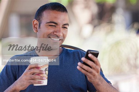 Man having cup of coffee outdoors