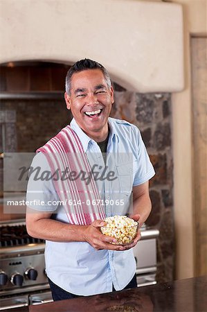 Man making popcorn in kitchen