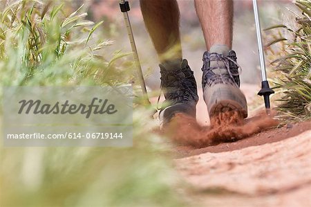 Hiker walking on dirt path Hiker walking on dirt path