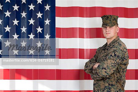Serviceman in camouflage by US flag