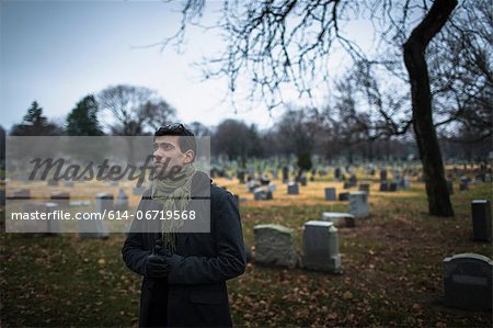 Man visiting graveyard