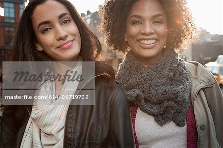 Smiling women on city street