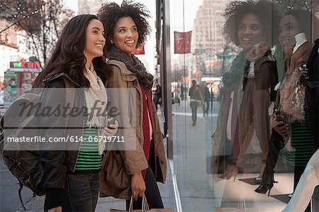 Women window shopping on city street Women window shopping on city street