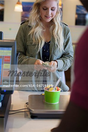 Customer paying for frozen yogurt