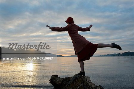 Woman balancing on rock formation