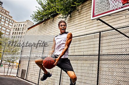 Man playing basketball on court