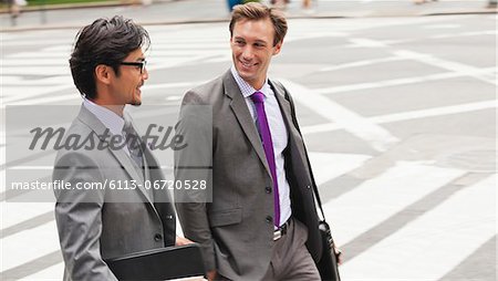 Businessmen talking on city street