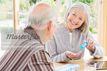 Caucasian couple organizing pills