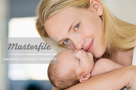Mother cradling newborn baby