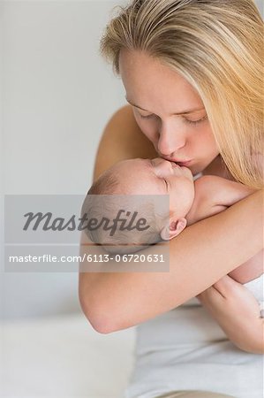 Mother kissing newborn baby