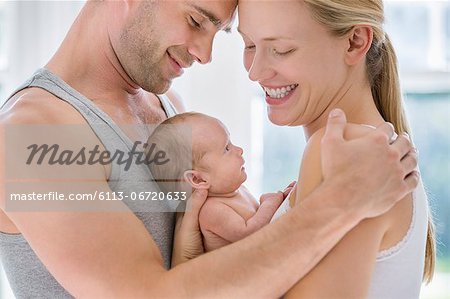 Parents cradling newborn baby