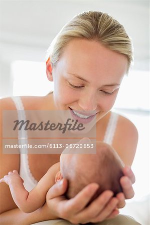 Mother cradling newborn baby