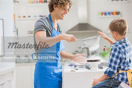 Father and son baking in kitchen