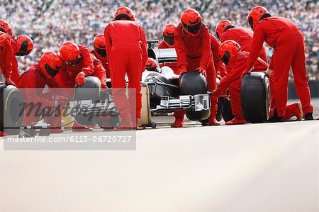 Race car team working at pit stop