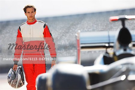 Racer carrying helmet on track