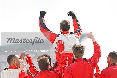 Racer and team cheering on track