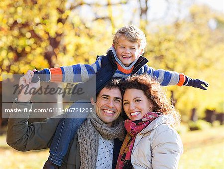 Family smiling together in park