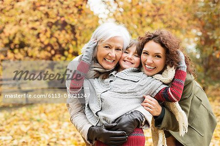 Three generations of women smiling in park