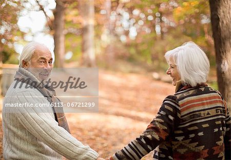 Older couple walking in park