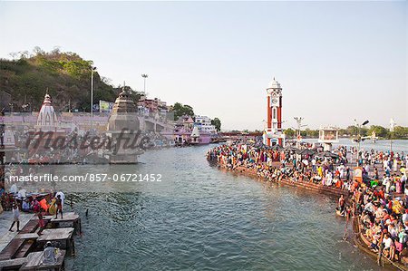 Crowd and a clock tower at Malviya Dwipa (island), River Ganges, Haridwar, Uttarakhand, India