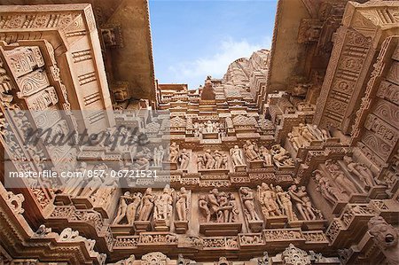 Low angle view of erotic carvings at a temple, Khajuraho, Chhatarpur District, Madhya Pradesh, India